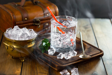 Fruit cocktail, in a glass with natural healthy fruits on a table with kitchen accessories.