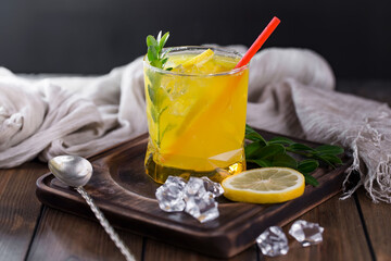 Fruit cocktail, in a glass with natural healthy fruits on a table with kitchen accessories.