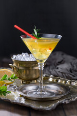 Cocktail in a glass with fruit on an old background.