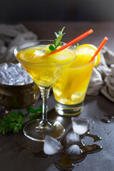 Cocktail in a glass with fruit on an old background.