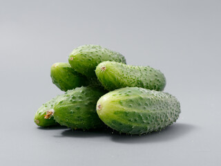 agricultural products green prickly cucumber on gray background