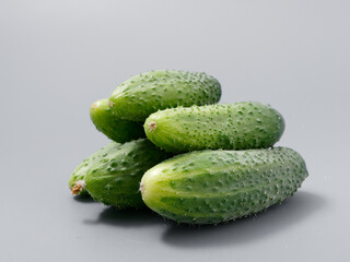 agricultural products green prickly cucumber on gray background