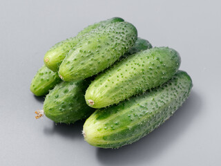 agricultural products green prickly cucumber on gray background