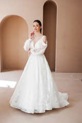 Fototapeta premium Smiling young woman posing in a wedding dress