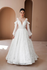 Smiling young woman posing in a wedding dress