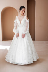 Fototapeta premium Smiling young woman posing in a wedding dress