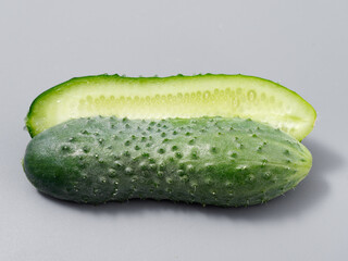 agricultural products green prickly cucumber on gray background