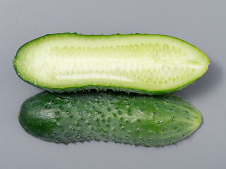 agricultural products green prickly cucumber on gray background