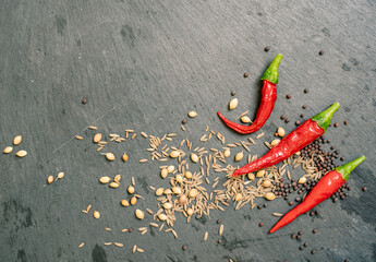 Spices and Chilli Peppers on Black Slate Tile