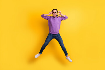 Fototapeta na wymiar Full length photo of young excited man happy positive smile jump up isolated over yellow color background