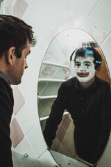 a man in front of a mirror looking for himself