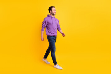 Fototapeta na wymiar Full body profile side photo of young handsome man happy positive smile go walk isolated over yellow color background