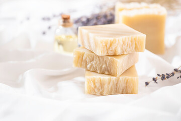 Natural handmade soap with lavender flowers on white silk. Aromatic natural soap. Organic soap.