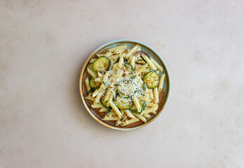 Obraz na płótnie Canvas Penne pasta with zucchini, sage, nuts and parmesan cheese. Healthy eating. Vegetarian food. Italian food.