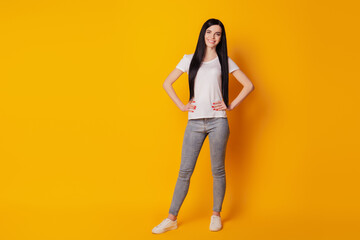 Fototapeta premium Full lenght photo of cool attractive girl happy positive smile wear casual outfit isolated yellow color background
