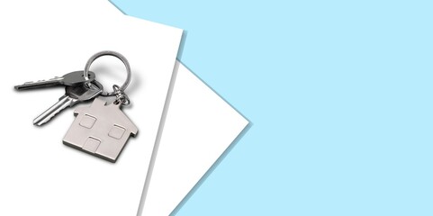 Keys and house keychain on real estate document, contract agreement to buy or construction