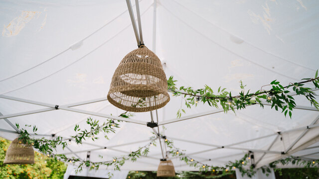 Hanging wicker decoration in white wedding tent