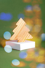 The zero waste new year concept as a wooden fir tree on the green background.