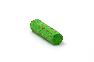 Old green crayon on white background, isolated