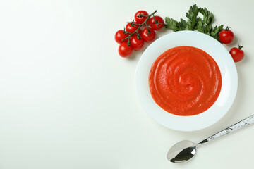 Gazpacho soup and ingredients on white background
