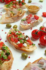 Delicious italian snacks bruschetta and ingredients on white background