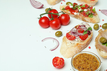 Delicious italian snacks bruschetta and ingredients on white background