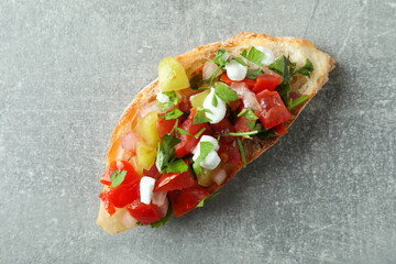 Delicious italian snack bruschetta on gray textured background