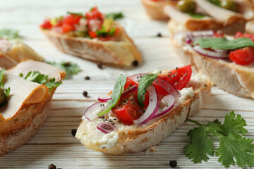 Delicious italian snacks bruschetta on white wooden background
