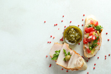Delicious bruschetta snacks on white textured background