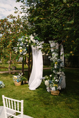 Beautiful outdoor wedding ceremony. Decorated chairs