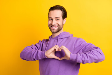 Photo of romantic boyfriend guy fingers show love heart symbol wear violet hoodie isolated yellow color background