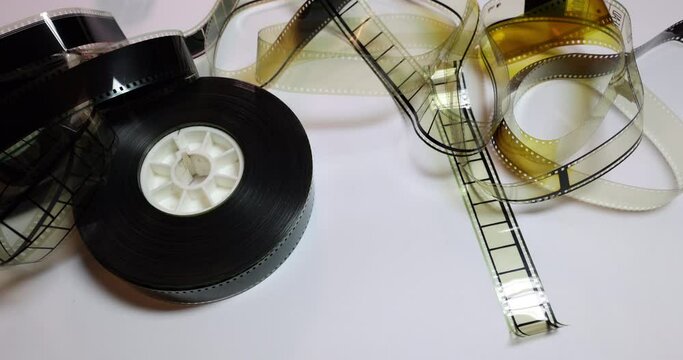 Side Tracking left to right on a film reel with some ruffled film clips