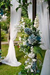Wedding arch at the exit registration on the green alley, floral decor