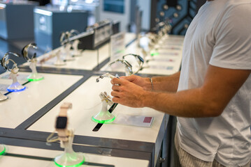 Buyer examining smartwatch in store