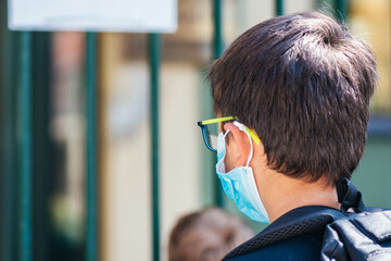 Back to school. Kid or child going to school wearing protective mask during COVID-19 or Coronavirus...