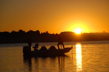 Silhouette of anglers and boat 