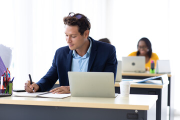 Business Man Entrepreneu working on laptop computer  colleague on background at home office.