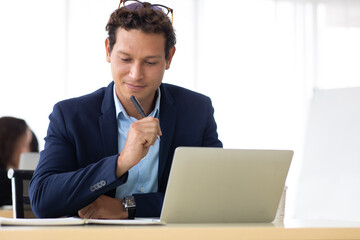 Business Man Entrepreneu working on laptop computer  colleague on background at home office.