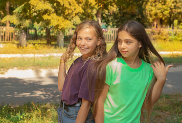Obraz premium Two girls outside with a background of autumn foliage. International day of girls child
