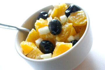 bowl of olives oranges and fennel salad typical dish of Sicilian cuisine in Italy on white background