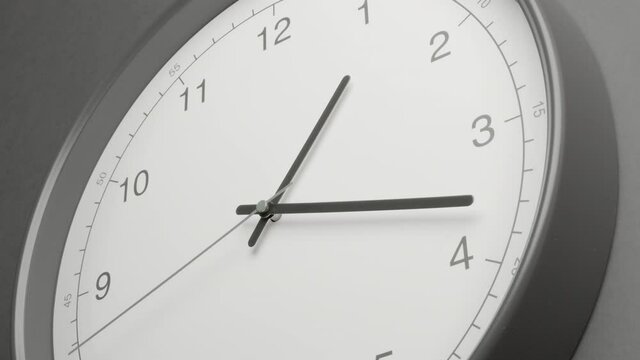 Clock Face on Dark Grey Office Wall in Timelapse