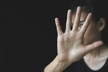 woman making NO or STOP gesture with hand, Stop drugs, Stop violence against children, stop violence against women, human rights violations, human trafficking