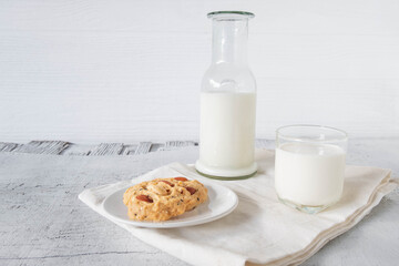 cookies and milk on white wooden background