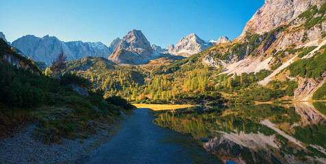 walkway along alpine lake Seebensee, with Mieminger Alps, hiking area Ehrwald
