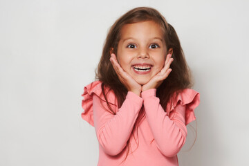 Portrait of surprised little girl against white background