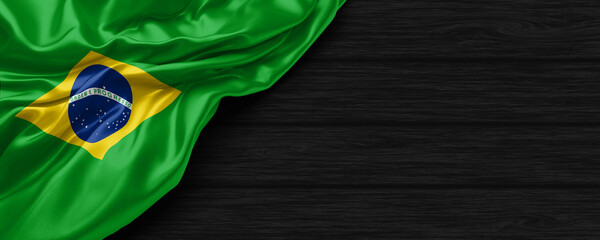 Close Up of Brazil flag on the black wooden background 3D render