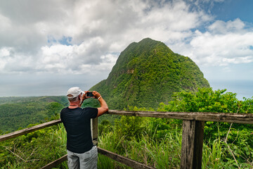 Man taking a photo at a scenic lookout along the Tet Paul Nature Trail in St. Lucia