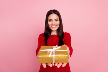Photo of joyful brunette lady give present wear red pullover isolated on pink color background