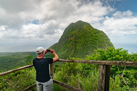 Man taking a photo at a scenic lookout along the Tet Paul Nature Trail in St. Lucia