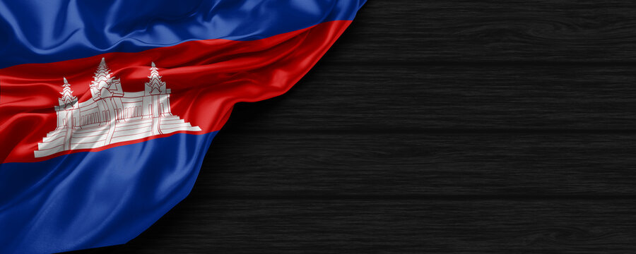Close Up of Cambodia flag on the black wooden background 3D render